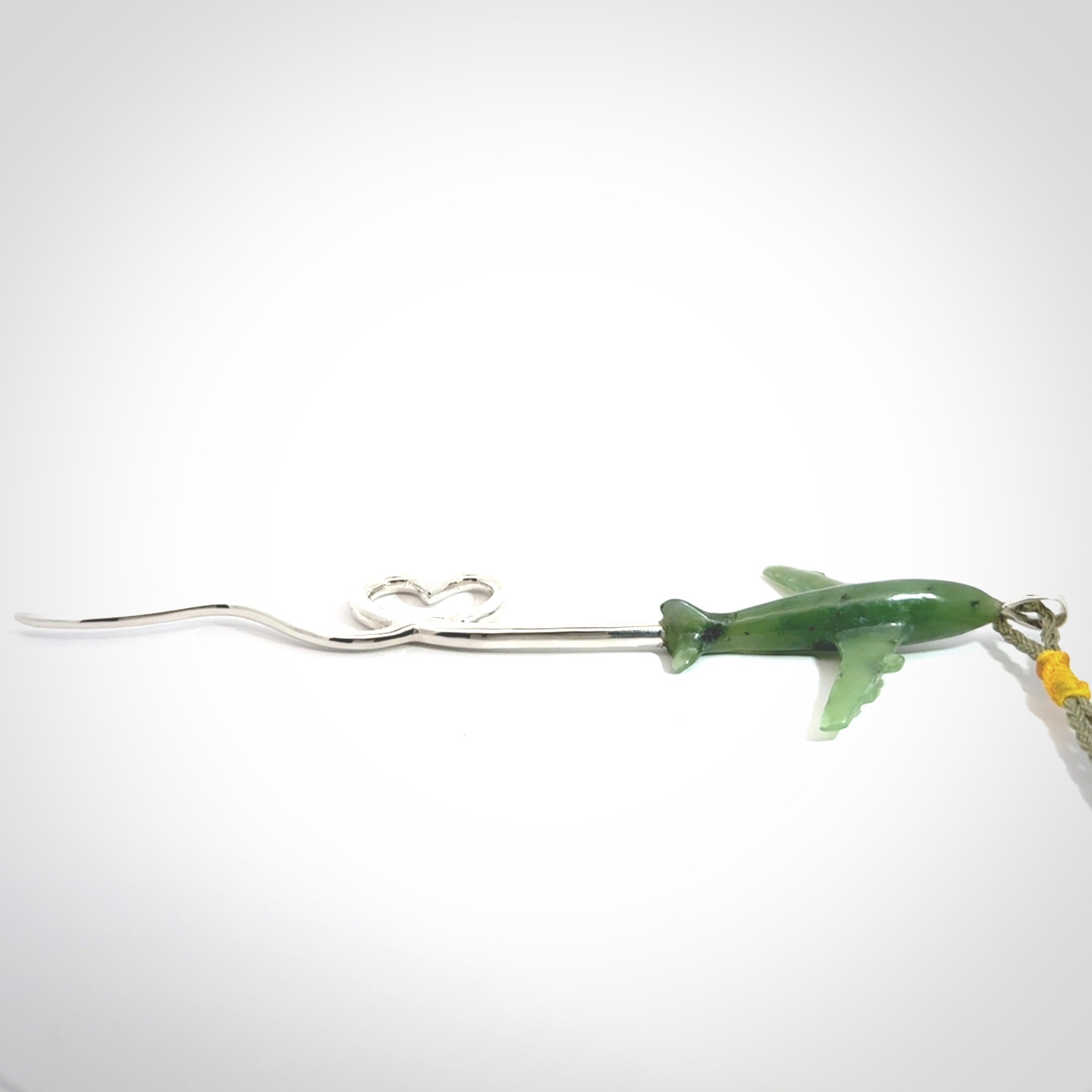 Hand carved plane and heart pendant from Jade with Sterling Silver. This is a very cool piece of jewellery, hand made by NZ Pacific. We provide this with an adjustable cord. Free Postage Worldwide.