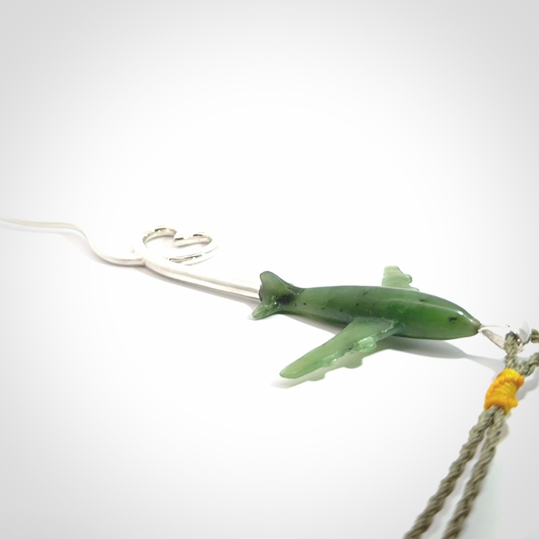 Hand carved plane and heart pendant from Jade with Sterling Silver. This is a very cool piece of jewellery, hand made by NZ Pacific. We provide this with an adjustable cord. Free Postage Worldwide.