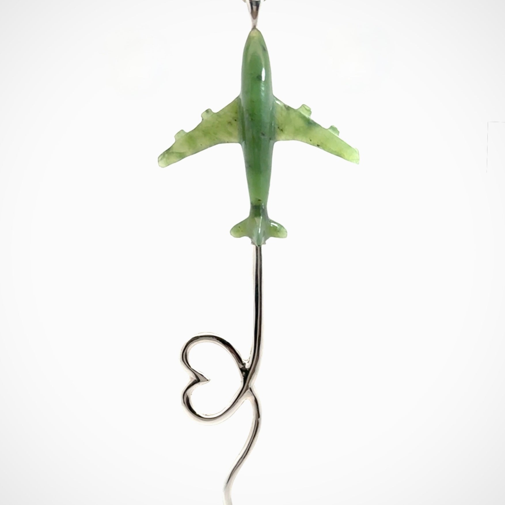 Hand carved plane and heart pendant from Jade with Sterling Silver. This is a very cool piece of jewellery, hand made by NZ Pacific. We provide this with an adjustable cord. Free Postage Worldwide.