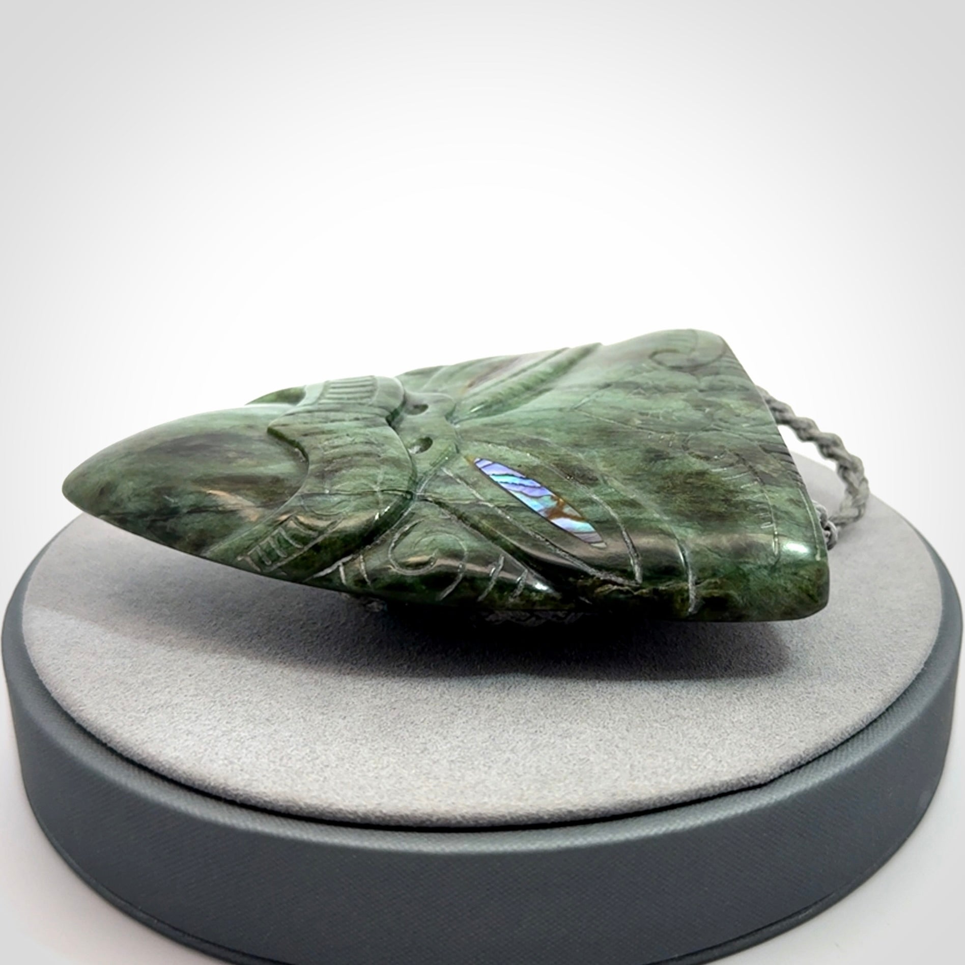 Hand carved New Zealand Jade wheku pendant with paua shell eyes