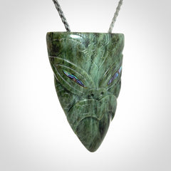Hand carved New Zealand Jade wheku pendant with paua shell eyes