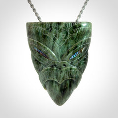 Hand carved New Zealand Jade wheku pendant with paua shell eyes