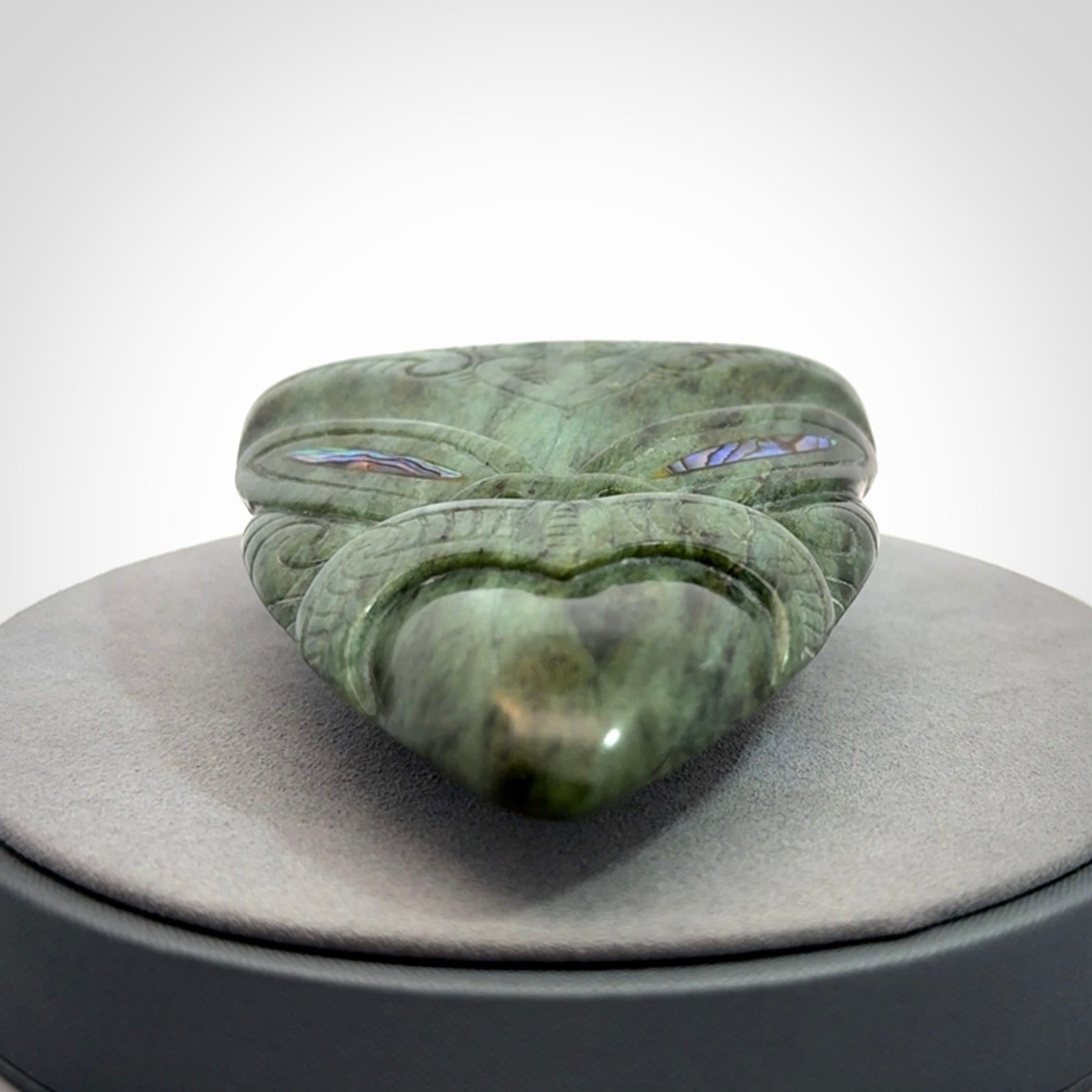 Hand carved New Zealand Jade wheku pendant with paua shell eyes