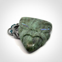 Hand carved New Zealand Jade wheku pendant with paua shell eyes