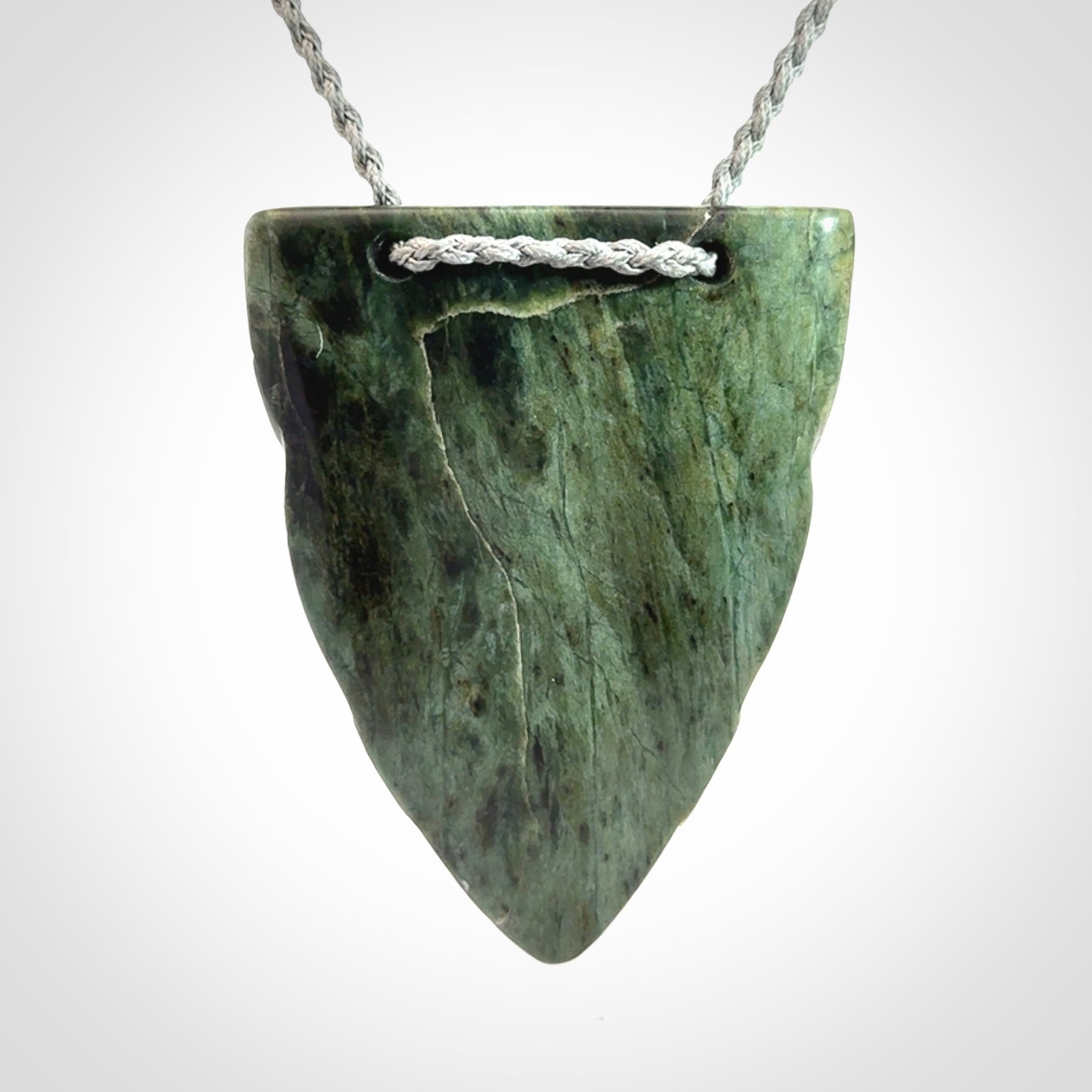 Hand carved New Zealand Jade wheku pendant with paua shell eyes