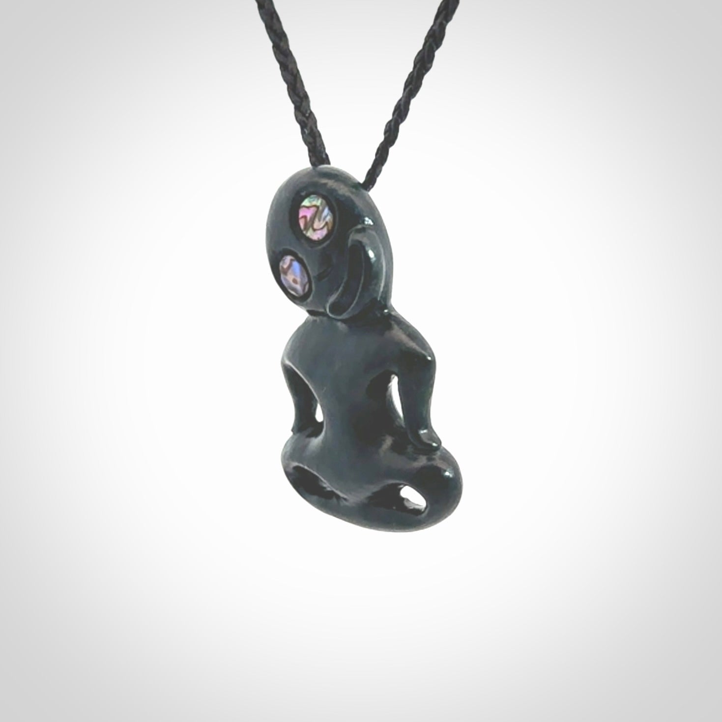 This pendant is a small jade tiki pendant. The carving shows wonderful detail on the front while the back is beautifully rounded. These are carved in New Zealand Jade with paua shell eyes. The cord is adjustable in length. Provided in a woven kete pouch and shipped worldwide.