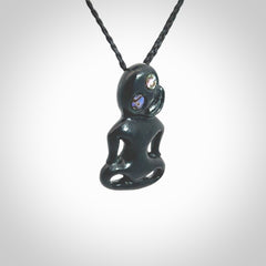 This pendant is a small jade tiki pendant. The carving shows wonderful detail on the front while the back is beautifully rounded. These are carved in New Zealand Jade with paua shell eyes. The cord is adjustable in length. Provided in a woven kete pouch and shipped worldwide.