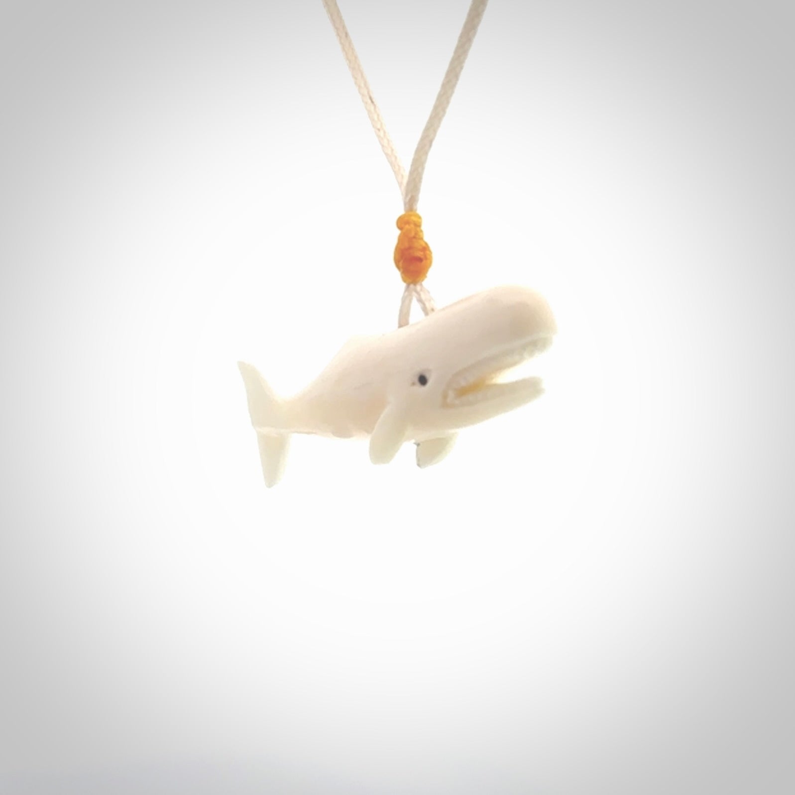 Hand carved bone contemporary sperm whale pendant. Hand carved by NZ Pacific. Free postage worldwide. Hand made whale necklace from bone. Ocean themed necklace for men and women.