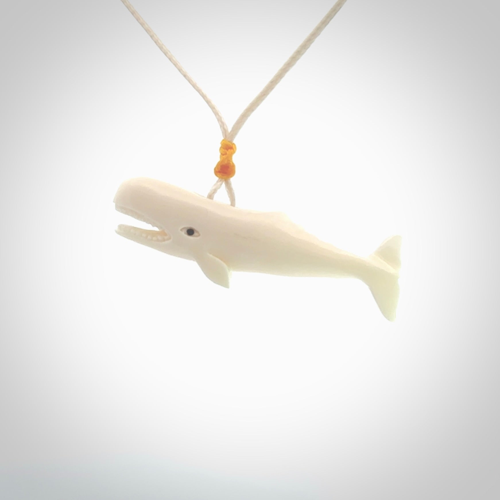 Hand carved bone contemporary sperm whale pendant. Hand carved by NZ Pacific. Free postage worldwide. Hand made whale necklace from bone. Ocean themed necklace for men and women.