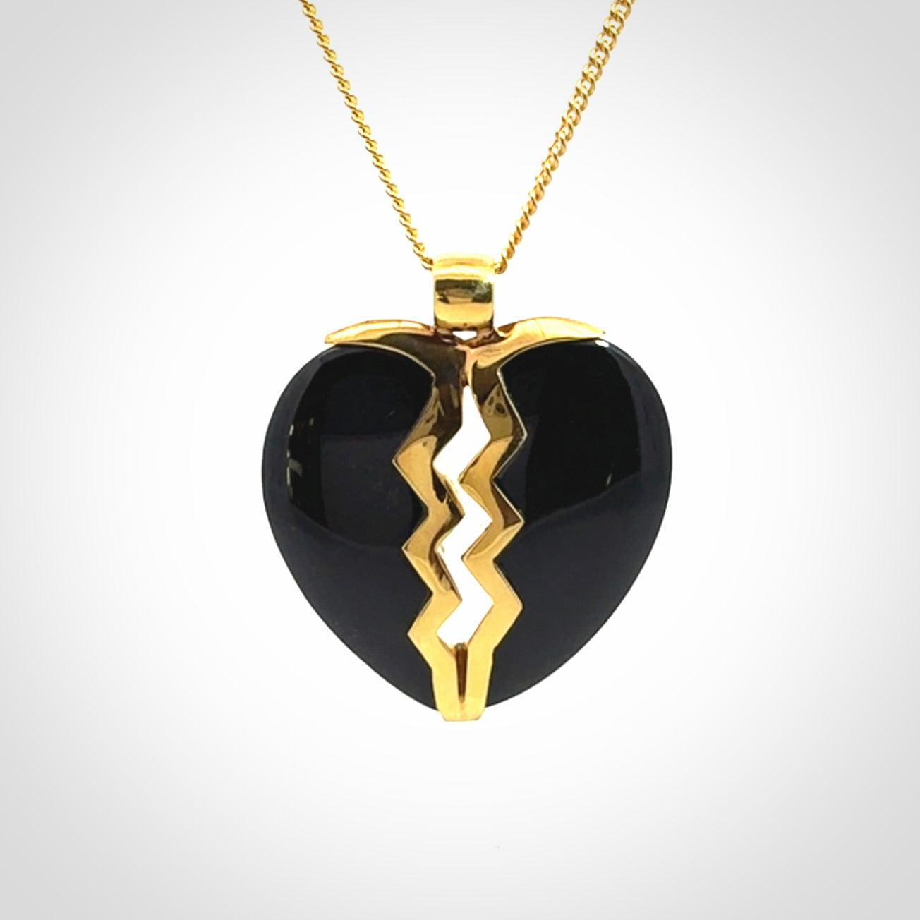 This is a handcarved love heart pendant made from a gorgeous and striking piece of Black Jade with gold plated silver. This is a superbly carved and very unique piece if custom jewellery. For sale online from NZ Pacific.
