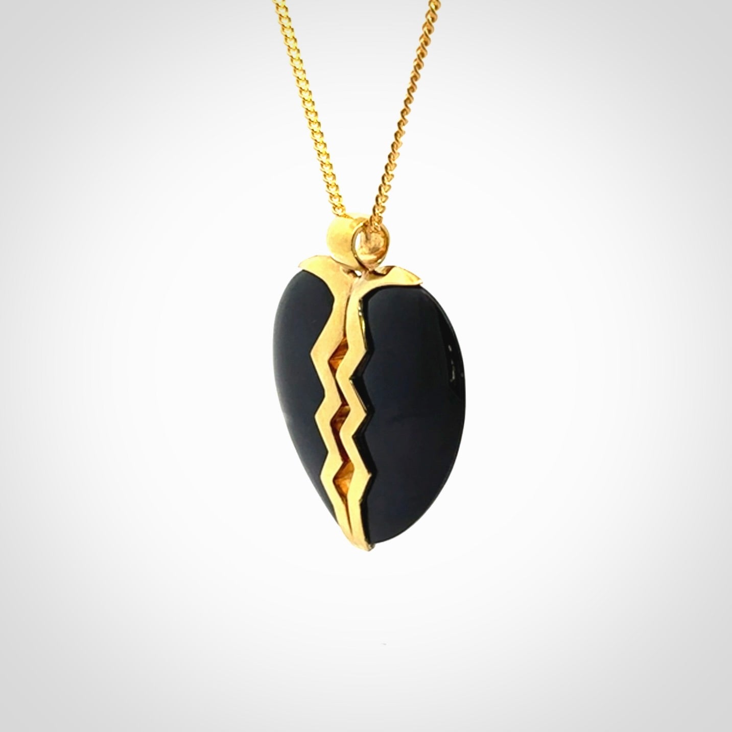 This is a handcarved love heart pendant made from a gorgeous and striking piece of Black Jade with gold plated silver. This is a superbly carved and very unique piece if custom jewellery. For sale online from NZ Pacific.