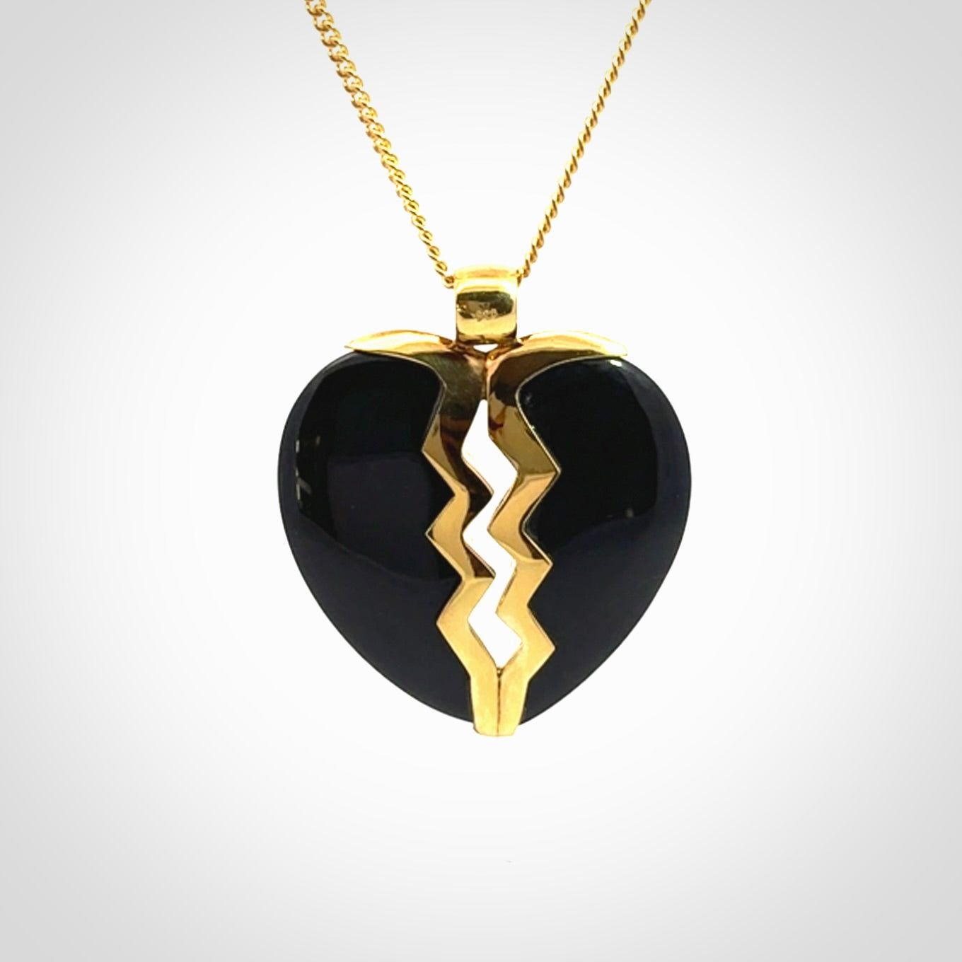 This is a handcarved love heart pendant made from a gorgeous and striking piece of Black Jade with gold plated silver. This is a superbly carved and very unique piece if custom jewellery. For sale online from NZ Pacific.