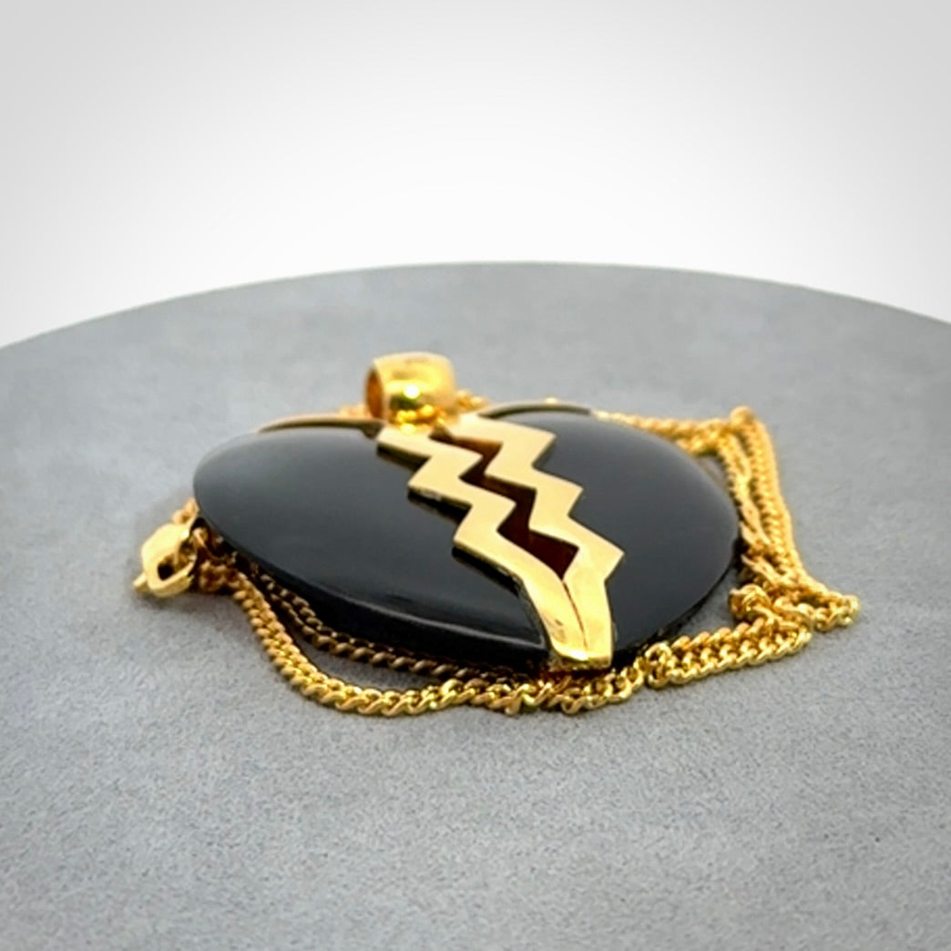 This is a handcarved love heart pendant made from a gorgeous and striking piece of Black Jade with gold plated silver. This is a superbly carved and very unique piece if custom jewellery. For sale online from NZ Pacific.