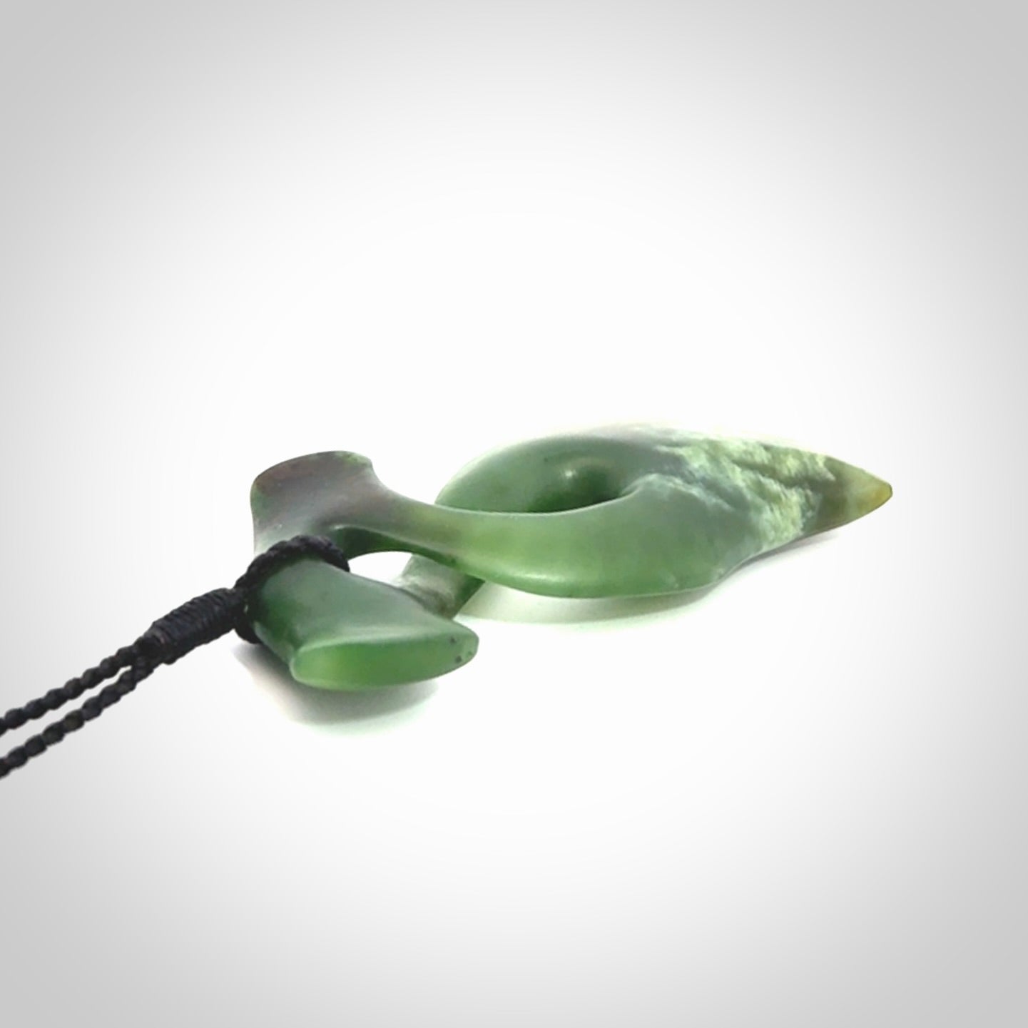 This hammerhead twist pendant is carved from a very striking New Zealand jade