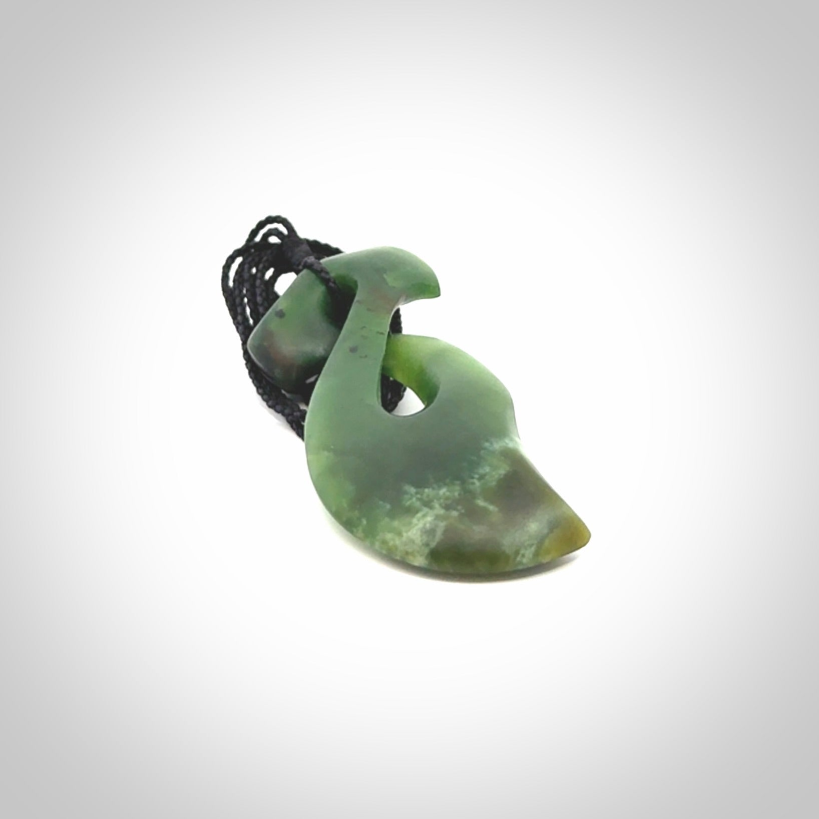 This hammerhead twist pendant is carved from a very striking New Zealand jade
