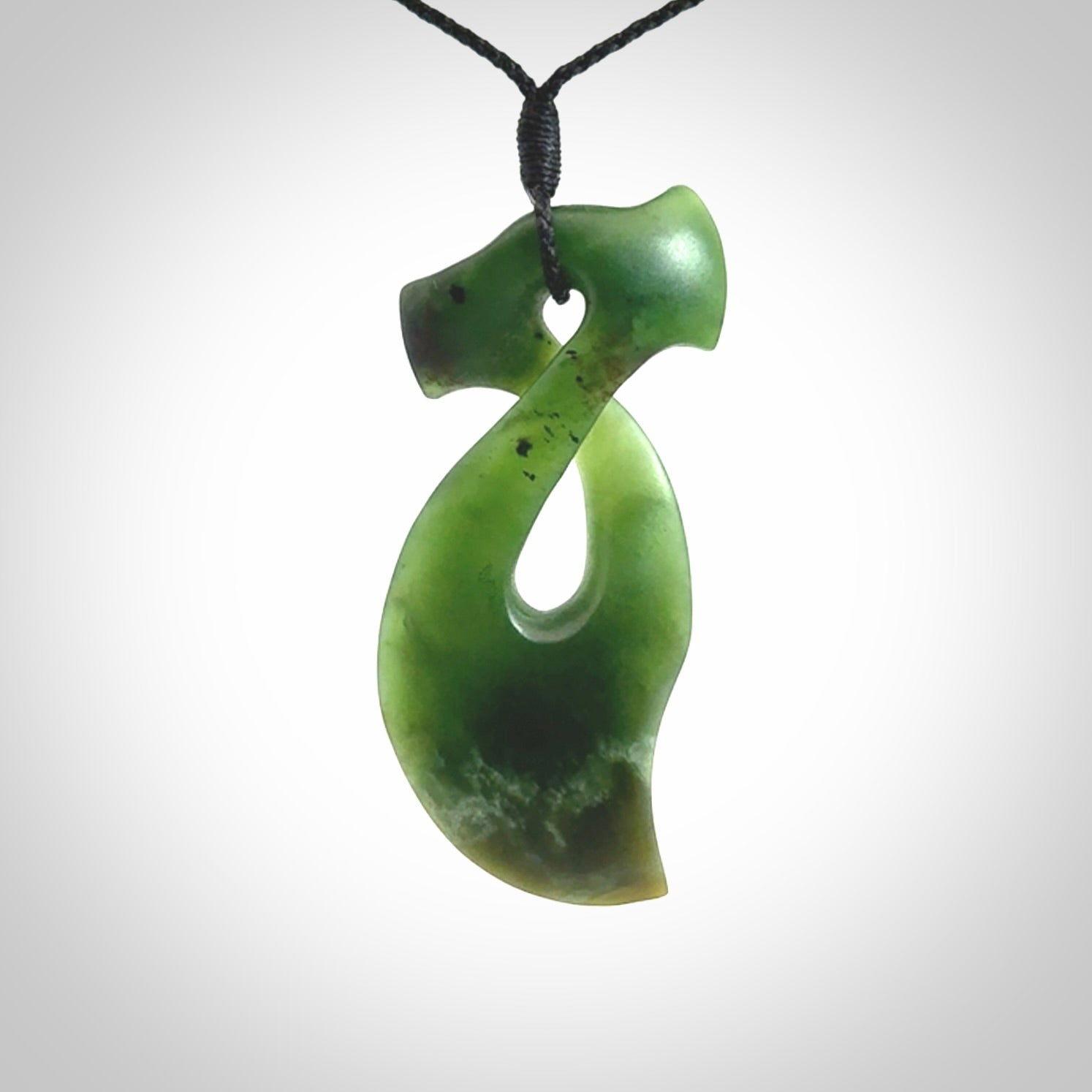 This hammerhead twist pendant is carved from a very striking New Zealand jade
