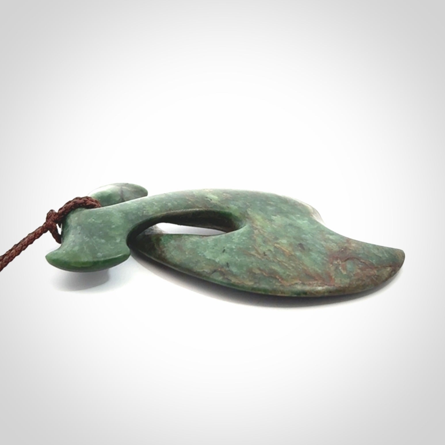 This hammerhead twist pendant is carved from a very striking New Zealand jade