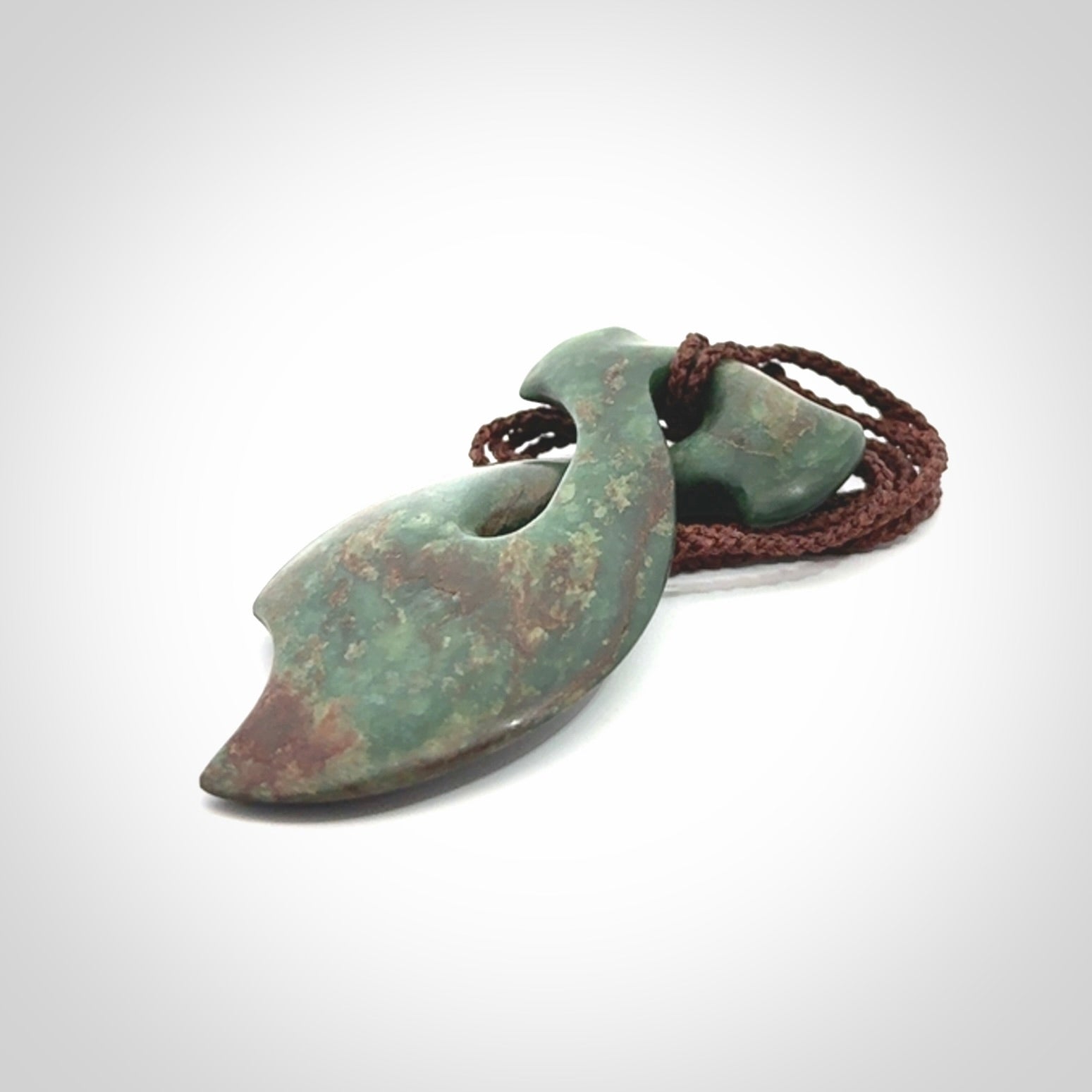 This hammerhead twist pendant is carved from a very striking New Zealand jade