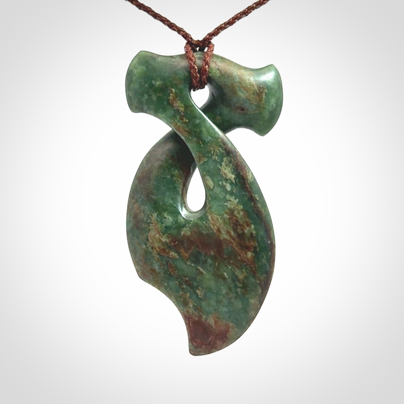 This hammerhead twist pendant is carved from a very striking New Zealand jade