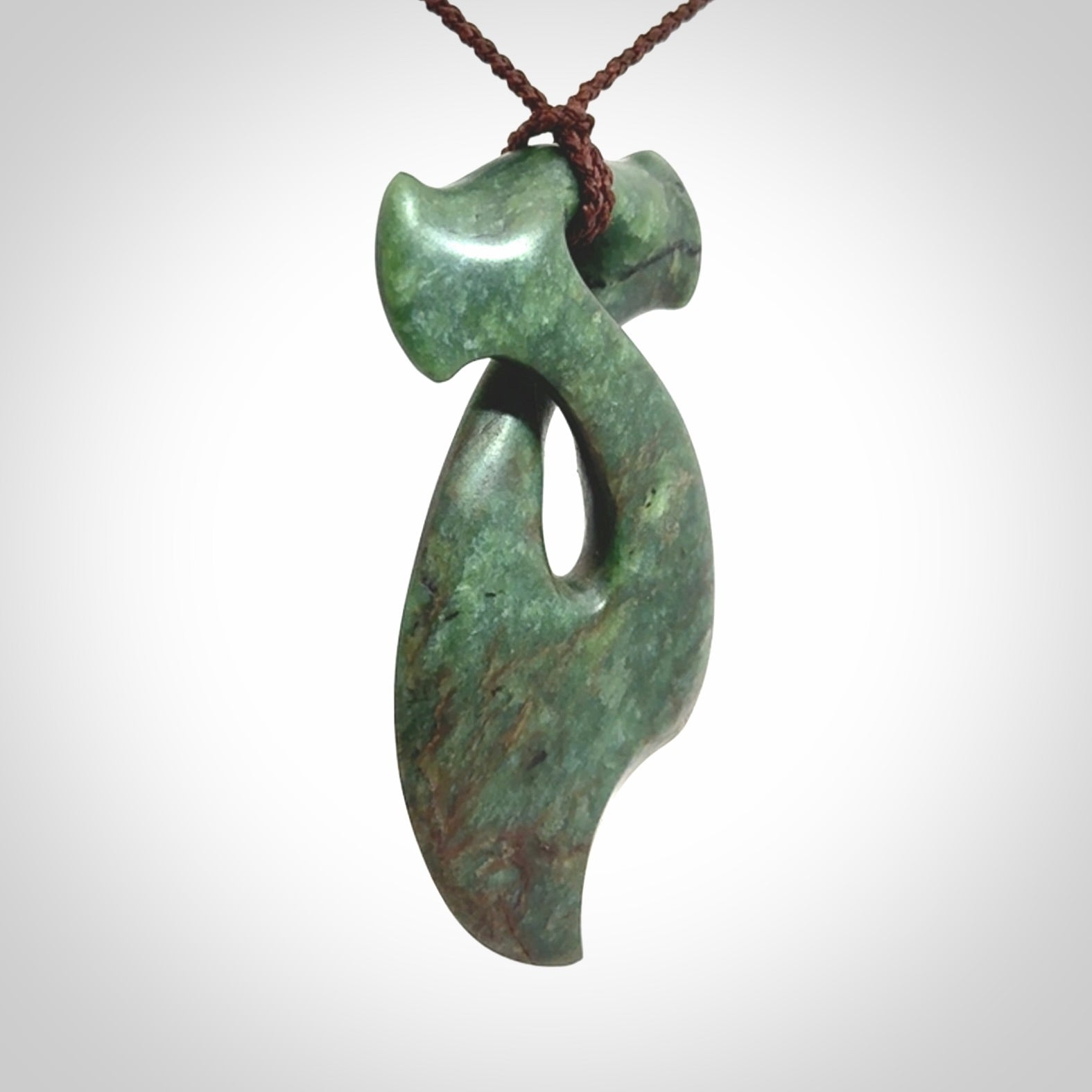 This hammerhead twist pendant is carved from a very striking New Zealand jade