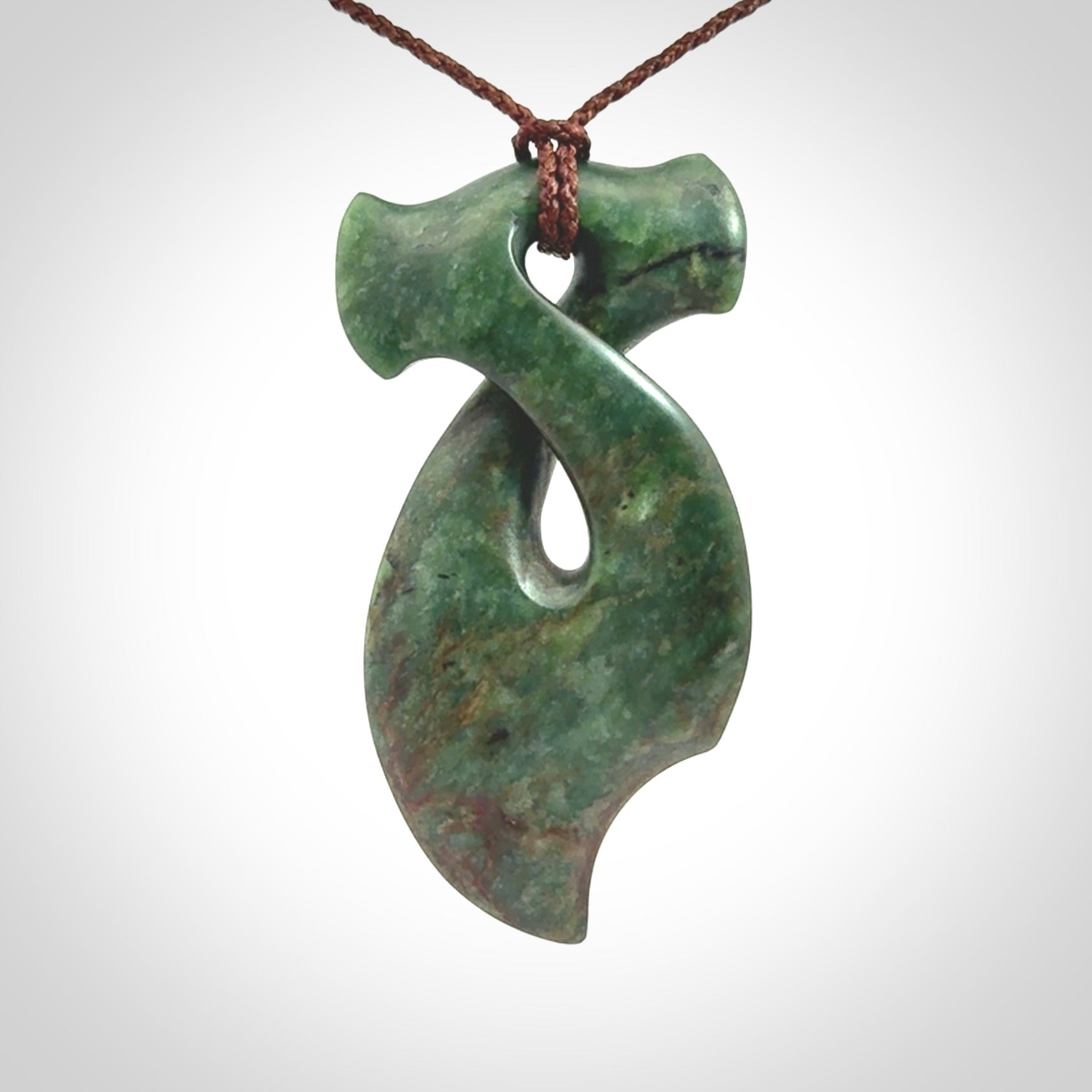 This hammerhead twist pendant is carved from a very striking New Zealand jade