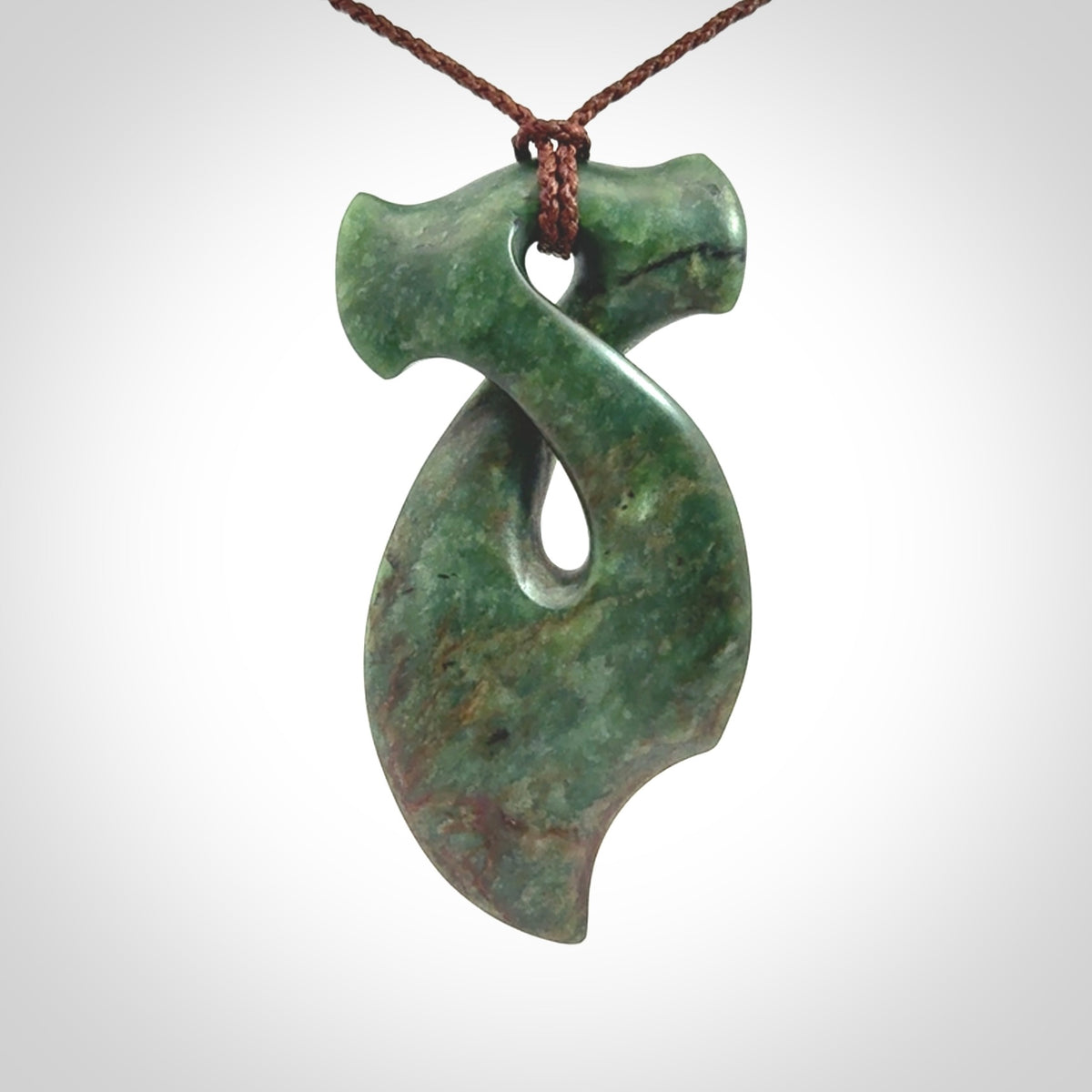 This hammerhead twist pendant is carved from a very striking New Zealand jade