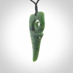 Hand carved huia bird skull made from New Zealand Marsden Jade pendant. Carved for NZ Pacific by Kyohei Noguchi. This is a contemporary piece of jewellery that is carved with intricate detail and clearly shows a beautiful bird skull. We ship this free worldwide with DHL Express Courier.