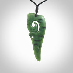 Hand carved huia bird skull made from New Zealand Marsden Jade pendant. Carved for NZ Pacific by Kyohei Noguchi. This is a contemporary piece of jewellery that is carved with intricate detail and clearly shows a beautiful bird skull. We ship this free worldwide with DHL Express Courier.