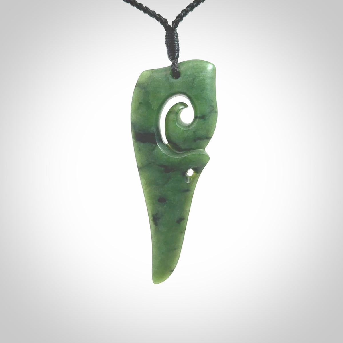 Hand carved huia bird skull made from New Zealand Marsden Jade pendant. Carved for NZ Pacific by Kyohei Noguchi. This is a contemporary piece of jewellery that is carved with intricate detail and clearly shows a beautiful bird skull. We ship this free worldwide with DHL Express Courier.