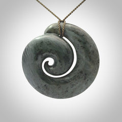 This pendant is a large sized koru necklace carved from a blue/grey piece of New Zealand Jade. Kyohei Noguchi carved this piece for us so the workmanship is outstanding. Handmade in New Zealand, a beautiful piece of jade jewellery.