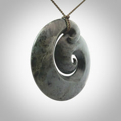 This pendant is a large sized koru necklace carved from a blue/grey piece of New Zealand Jade. Kyohei Noguchi carved this piece for us so the workmanship is outstanding. Handmade in New Zealand, a beautiful piece of jade jewellery.