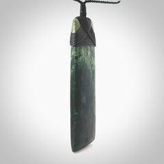 Hand carved from a lovely piece of local New Zealand Marsden Jade. The quality of the workmanship and design is outstanding - this is a piece you will want to wear all the time. We have suspended this from a 4-plait black cord which can be adjusted with a couple of slip knots and black binding. Hand made by Kyohei Noguchi.