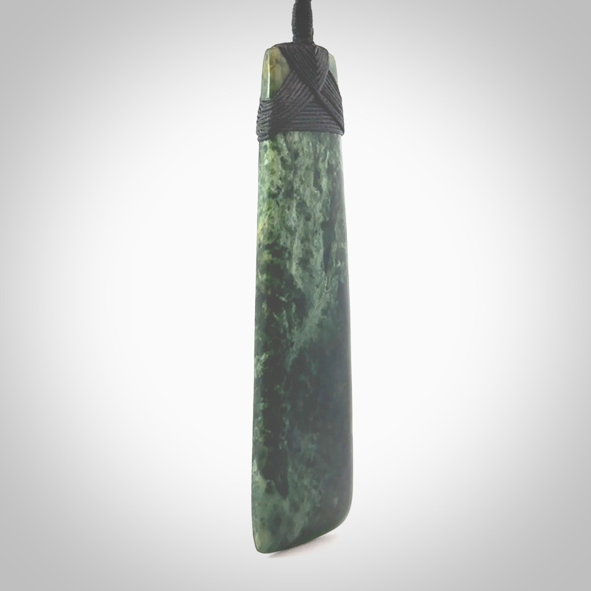 Hand carved from a lovely piece of local New Zealand Marsden Jade. The quality of the workmanship and design is outstanding - this is a piece you will want to wear all the time. We have suspended this from a 4-plait black cord which can be adjusted with a couple of slip knots and black binding. Hand made by Kyohei Noguchi.