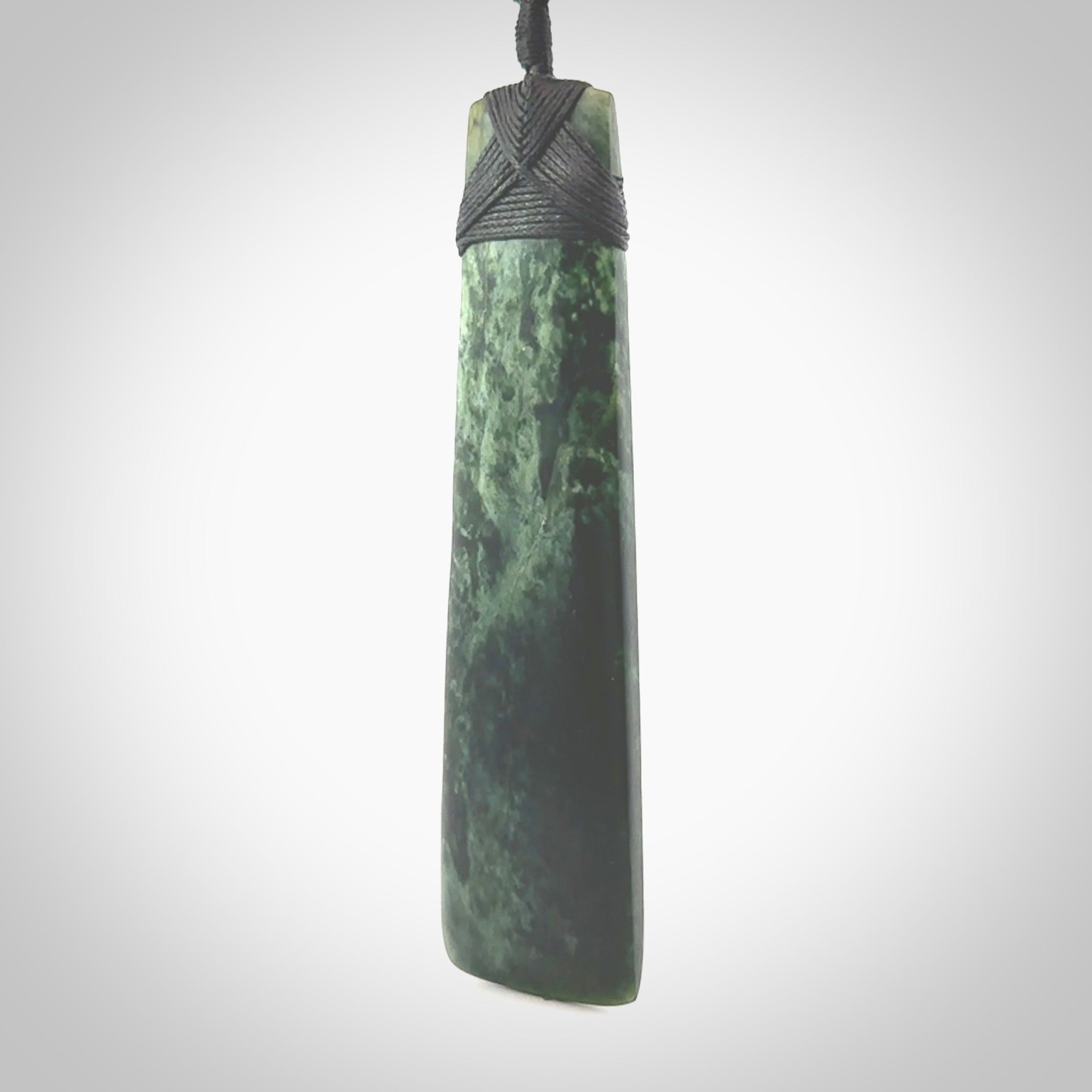 Hand carved from a lovely piece of local New Zealand Marsden Jade. The quality of the workmanship and design is outstanding - this is a piece you will want to wear all the time. We have suspended this from a 4-plait black cord which can be adjusted with a couple of slip knots and black binding. Hand made by Kyohei Noguchi.