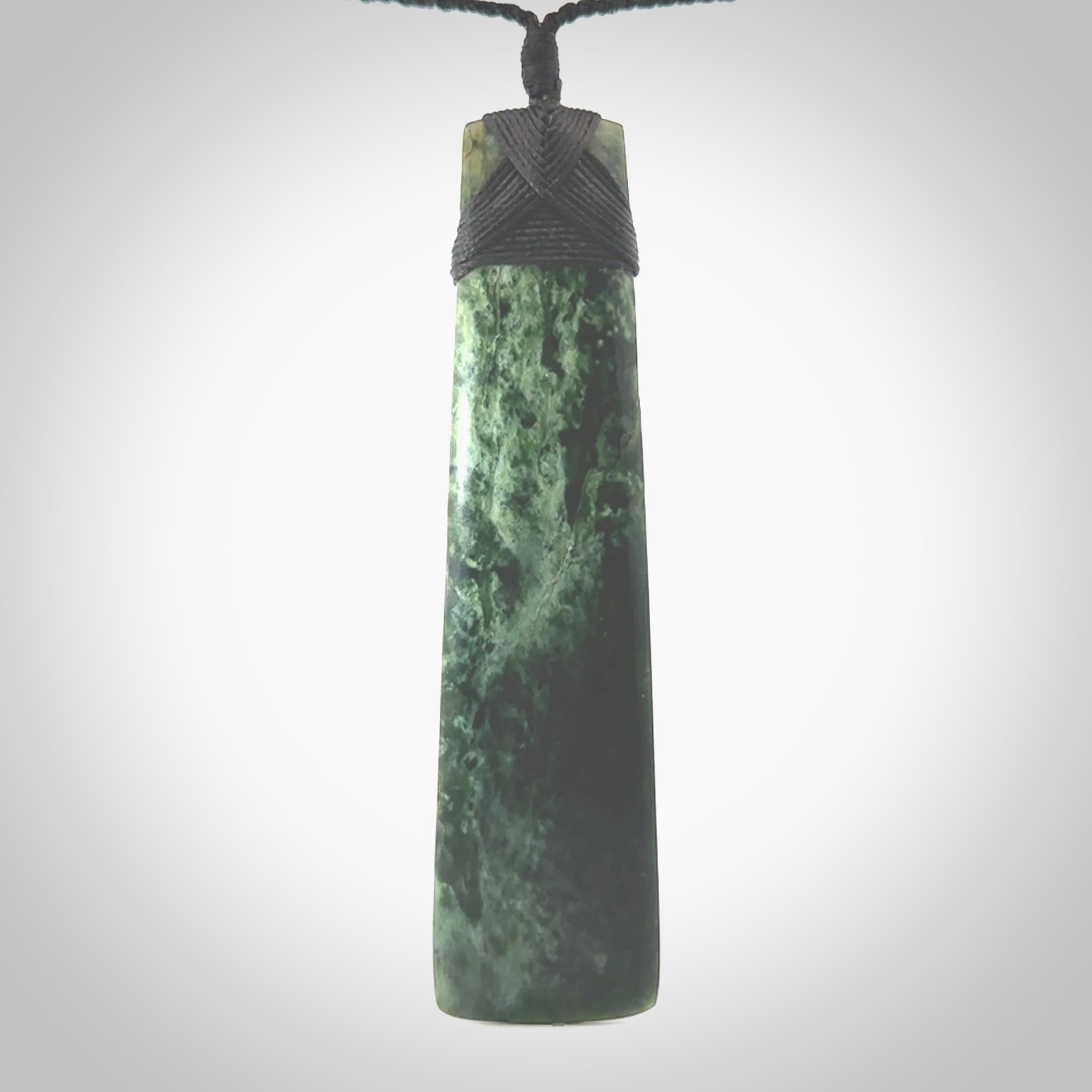 Hand carved from a lovely piece of local New Zealand Marsden Jade. The quality of the workmanship and design is outstanding - this is a piece you will want to wear all the time. We have suspended this from a 4-plait black cord which can be adjusted with a couple of slip knots and black binding. Hand made by Kyohei Noguchi.