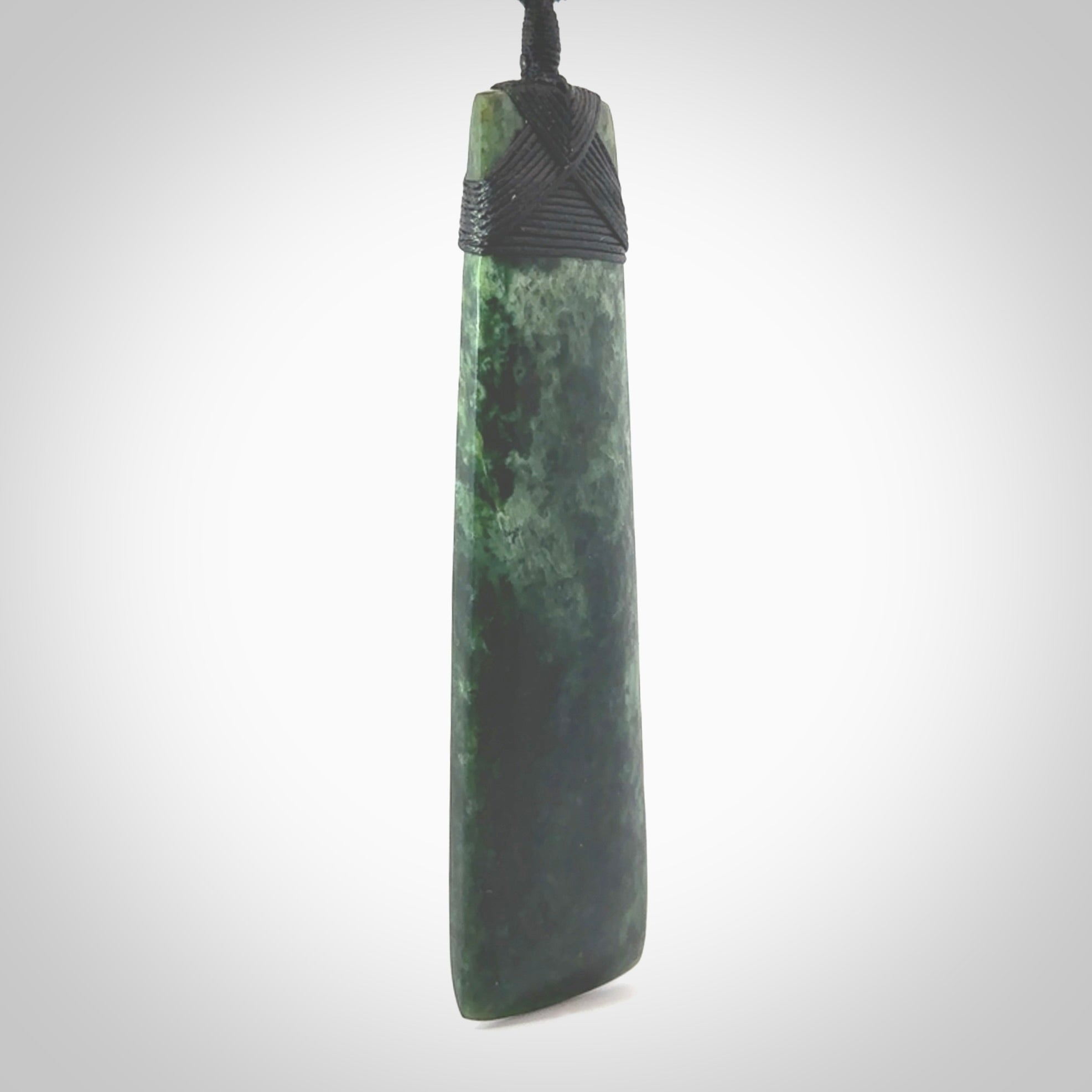 Hand carved from a lovely piece of local New Zealand Marsden Jade. The quality of the workmanship and design is outstanding - this is a piece you will want to wear all the time. We have suspended this from a 4-plait black cord which can be adjusted with a couple of slip knots and black binding. Hand made by Kyohei Noguchi.