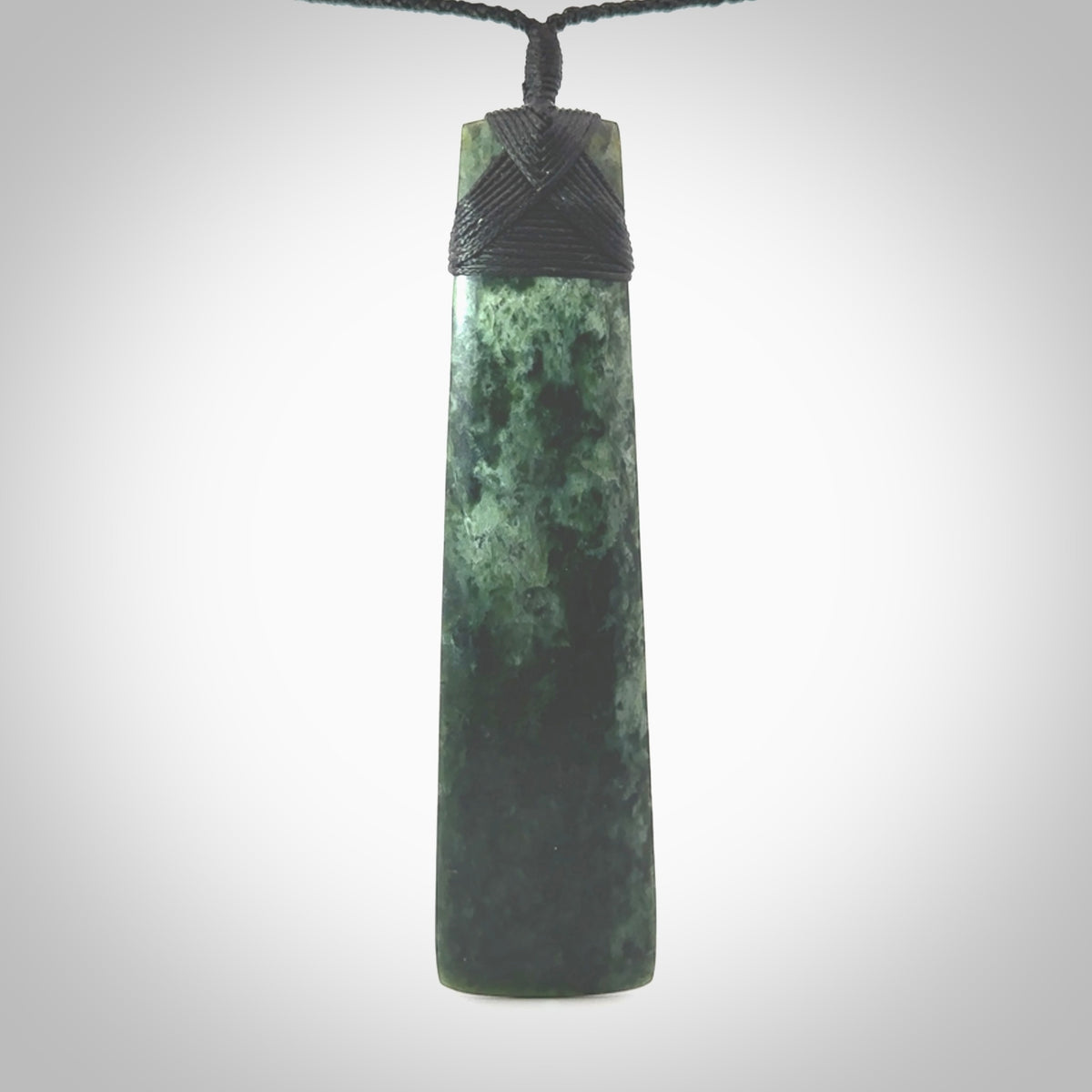 Hand carved from a lovely piece of local New Zealand Marsden Jade. The quality of the workmanship and design is outstanding - this is a piece you will want to wear all the time. We have suspended this from a 4-plait black cord which can be adjusted with a couple of slip knots and black binding. Hand made by Kyohei Noguchi.