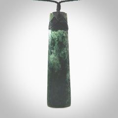 Hand carved from a lovely piece of local New Zealand Marsden Jade. The quality of the workmanship and design is outstanding - this is a piece you will want to wear all the time. We have suspended this from a 4-plait black cord which can be adjusted with a couple of slip knots and black binding. Hand made by Kyohei Noguchi.