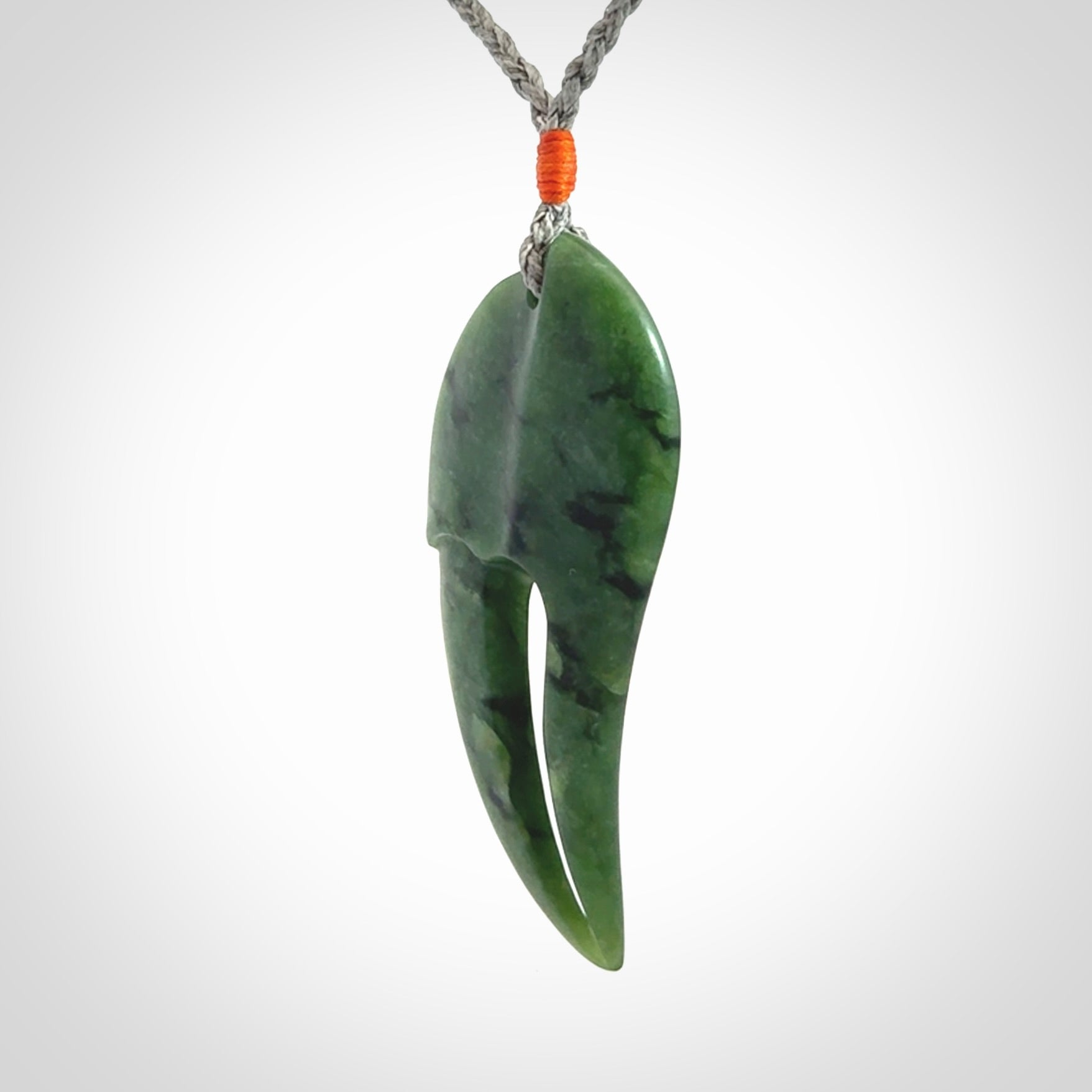 This large crab claw pendant is carved from a lovely deep green piece of New Zealand jade. It has an adjustable silver coloured cord which can be slipped over the head and adjusted to the length that you prefer. Hand carved in New Zealand from our local jade by Kyohei Noguchi.
