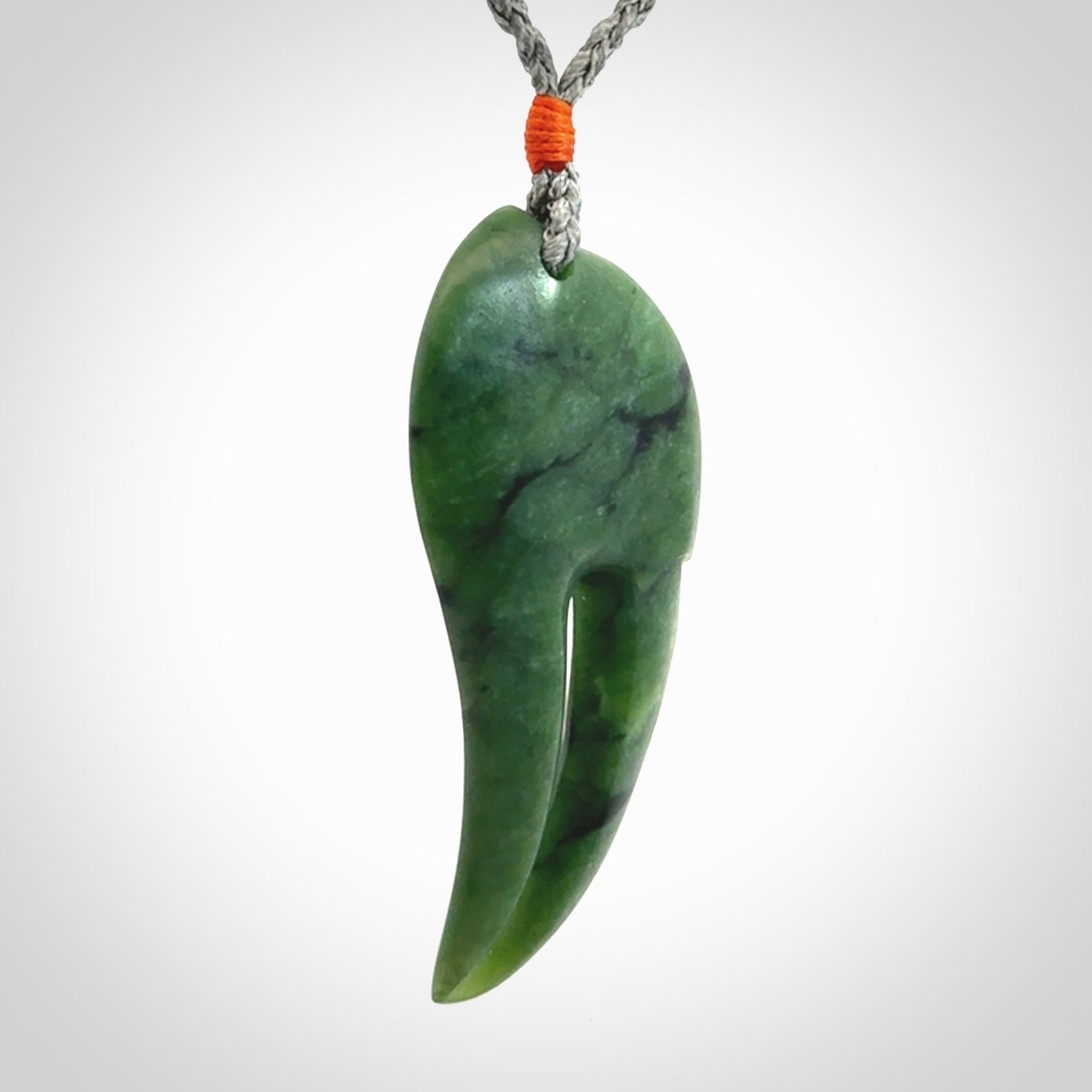 This large crab claw pendant is carved from a lovely deep green piece of New Zealand jade. It has an adjustable silver coloured cord which can be slipped over the head and adjusted to the length that you prefer. Hand carved in New Zealand from our local jade by Kyohei Noguchi.