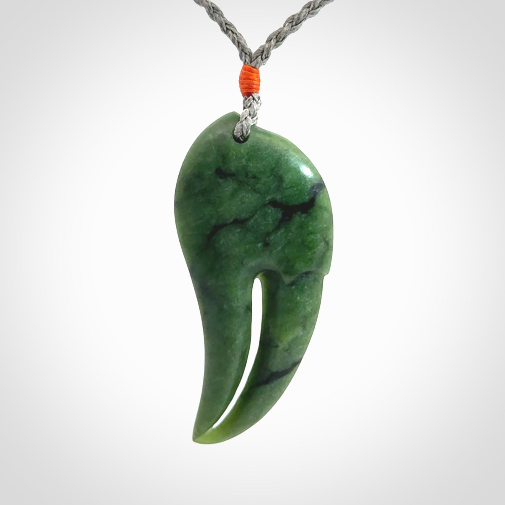 This large crab claw pendant is carved from a lovely deep green piece of New Zealand jade. It has an adjustable silver coloured cord which can be slipped over the head and adjusted to the length that you prefer. Hand carved in New Zealand from our local jade by Kyohei Noguchi.