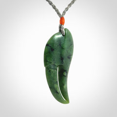 This large crab claw pendant is carved from a lovely deep green piece of New Zealand jade. It has an adjustable silver coloured cord which can be slipped over the head and adjusted to the length that you prefer. Hand carved in New Zealand from our local jade by Kyohei Noguchi.