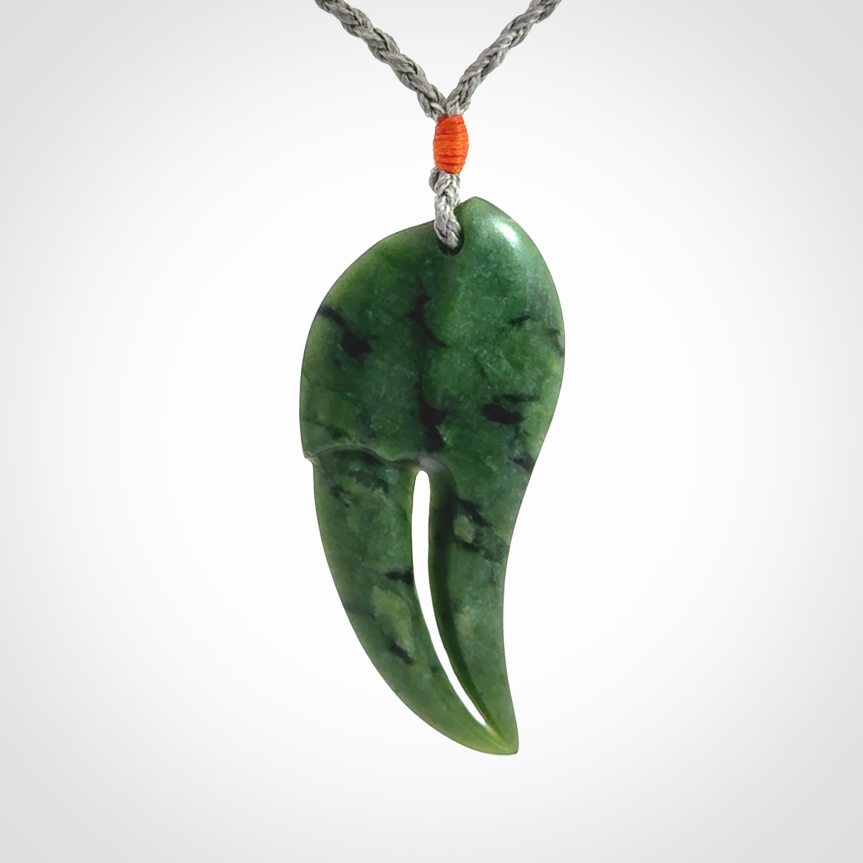This large crab claw pendant is carved from a lovely deep green piece of New Zealand jade. It has an adjustable silver coloured cord which can be slipped over the head and adjusted to the length that you prefer. Hand carved in New Zealand from our local jade by Kyohei Noguchi.