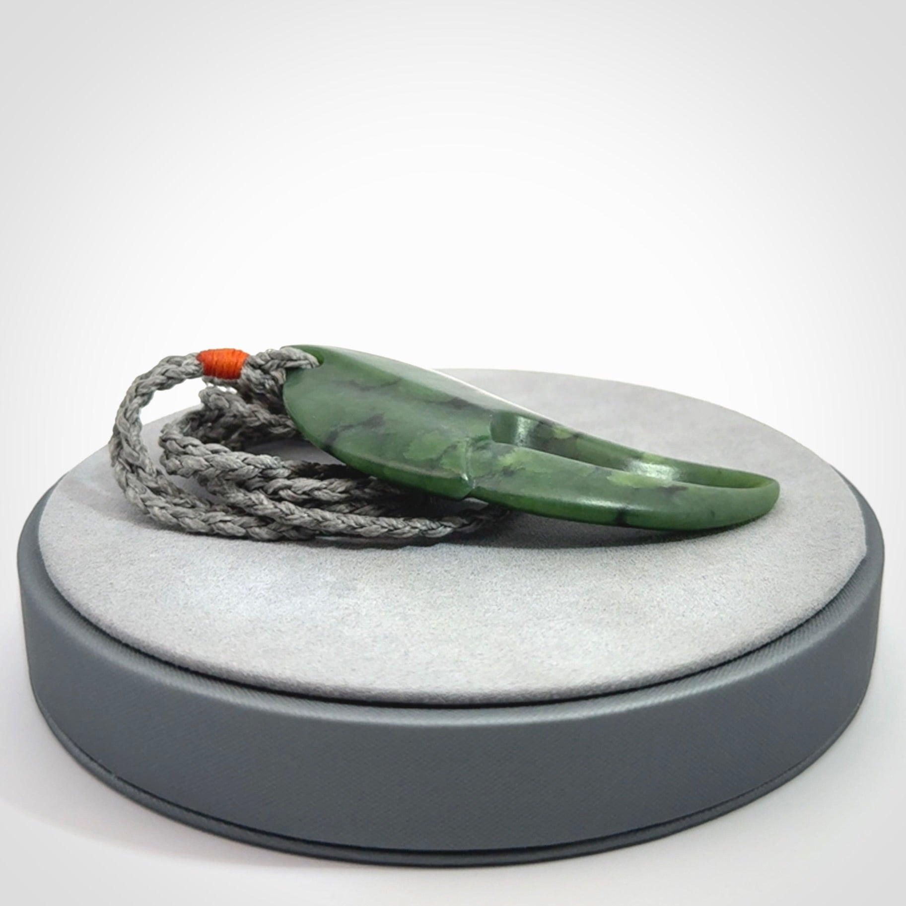 This large crab claw pendant is carved from a lovely deep green piece of New Zealand jade. It has an adjustable silver coloured cord which can be slipped over the head and adjusted to the length that you prefer. Hand carved in New Zealand from our local jade by Kyohei Noguchi.