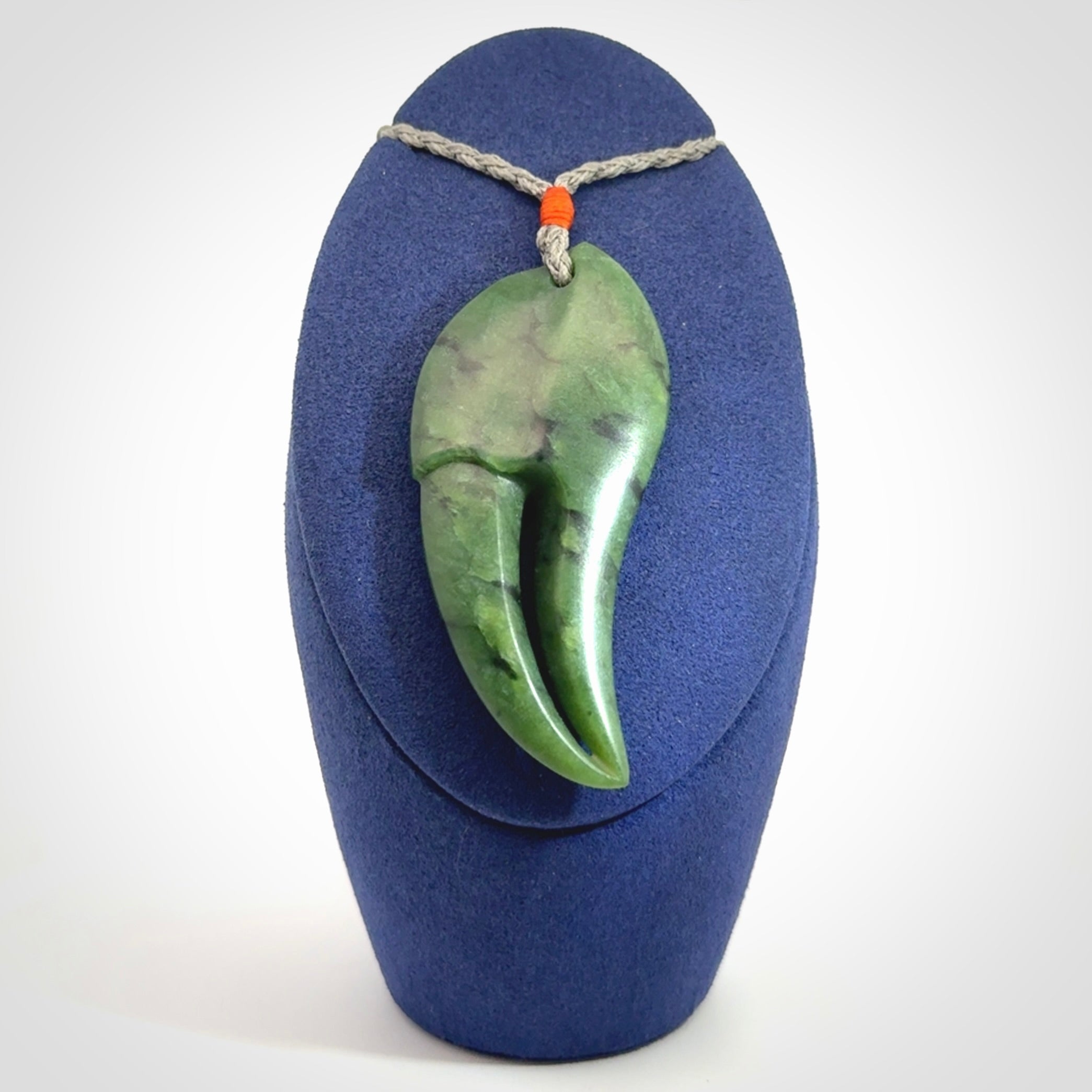This large crab claw pendant is carved from a lovely deep green piece of New Zealand jade. It has an adjustable silver coloured cord which can be slipped over the head and adjusted to the length that you prefer. Hand carved in New Zealand from our local jade by Kyohei Noguchi.