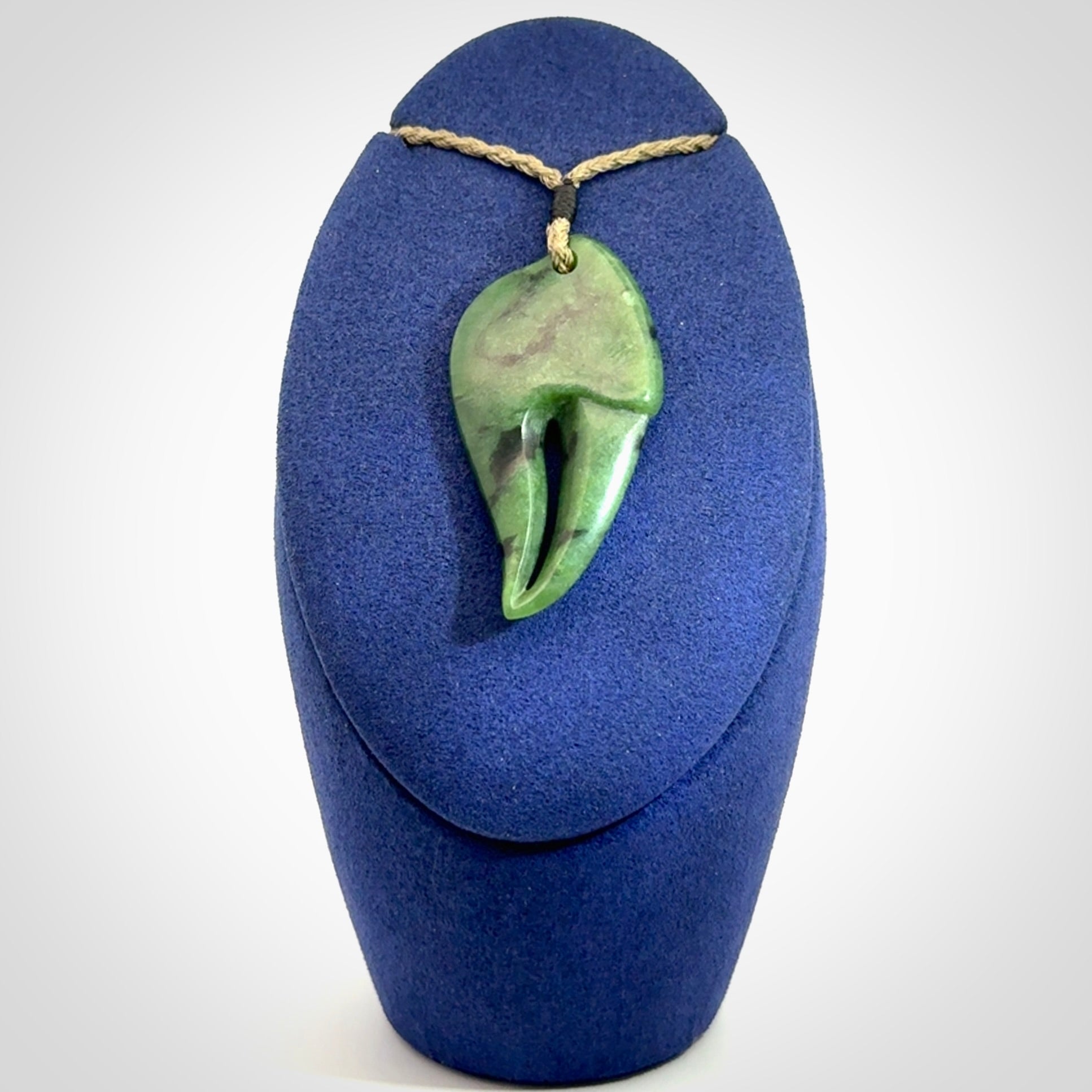 This large crab claw pendant is carved from a lovely deep green piece of New Zealand jade. It has an adjustable Khaki coloured cord which can be slipped over the head and adjusted to the length that you prefer. Hand carved in New Zealand from our local jade by Kyohei Noguchi.