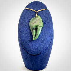This large crab claw pendant is carved from a lovely deep green piece of New Zealand jade. It has an adjustable Khaki coloured cord which can be slipped over the head and adjusted to the length that you prefer. Hand carved in New Zealand from our local jade by Kyohei Noguchi.