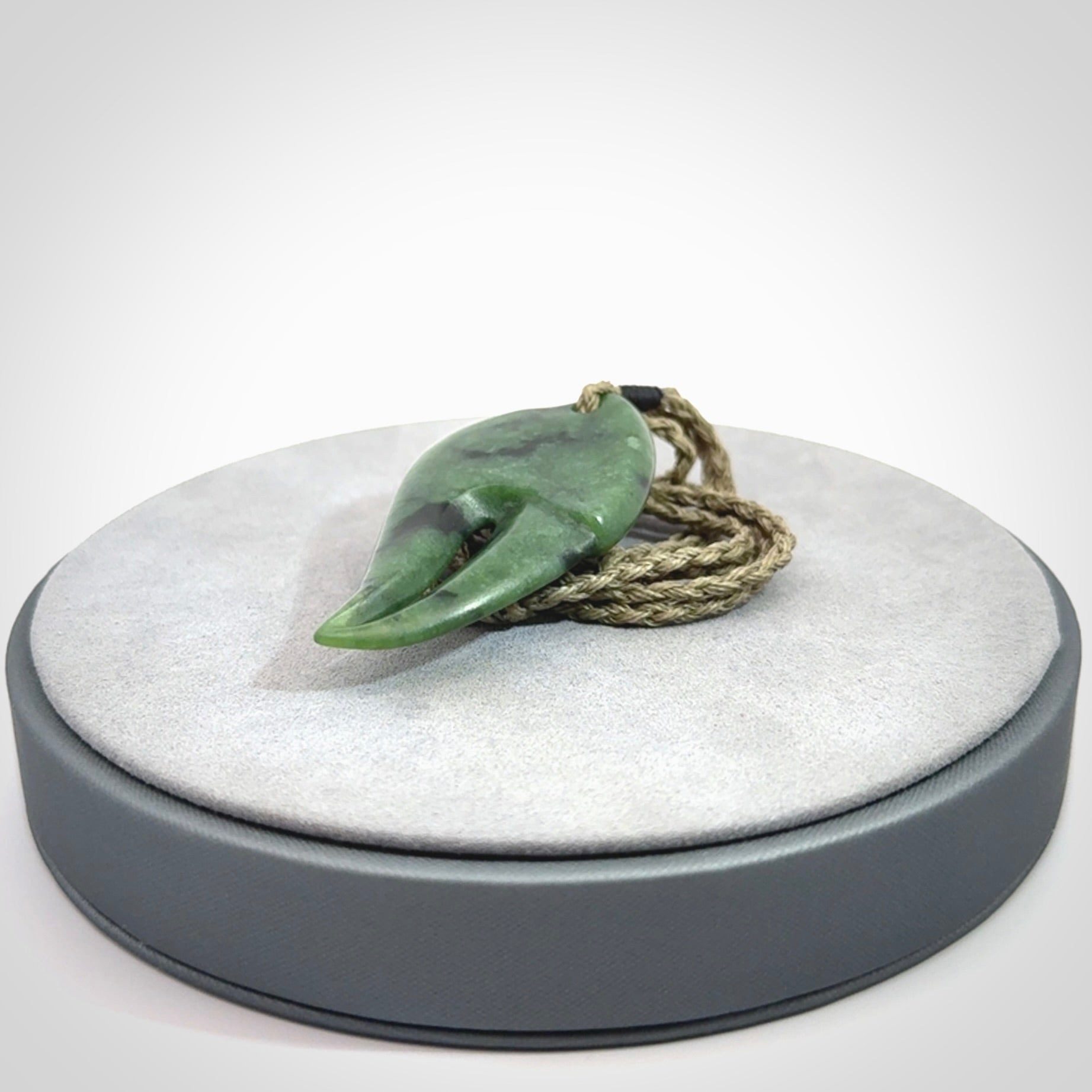 This large crab claw pendant is carved from a lovely deep green piece of New Zealand jade. It has an adjustable Khaki coloured cord which can be slipped over the head and adjusted to the length that you prefer. Hand carved in New Zealand from our local jade by Kyohei Noguchi.