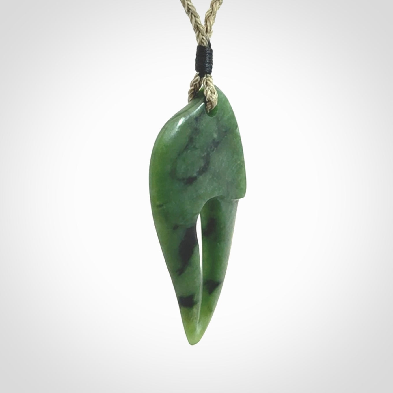 This large crab claw pendant is carved from a lovely deep green piece of New Zealand jade. It has an adjustable Khaki coloured cord which can be slipped over the head and adjusted to the length that you prefer. Hand carved in New Zealand from our local jade by Kyohei Noguchi.