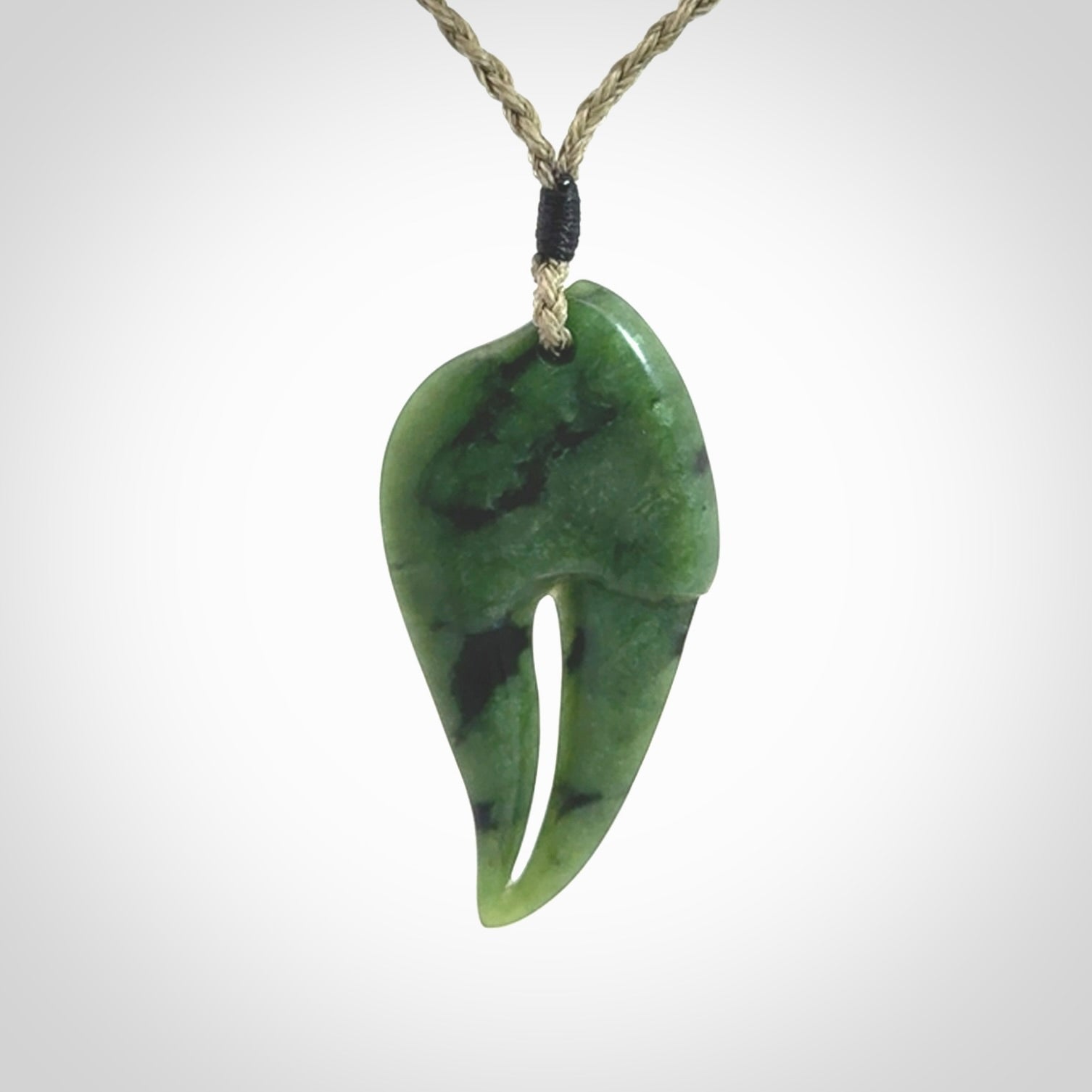 This large crab claw pendant is carved from a lovely deep green piece of New Zealand jade. It has an adjustable Khaki coloured cord which can be slipped over the head and adjusted to the length that you prefer. Hand carved in New Zealand from our local jade by Kyohei Noguchi.